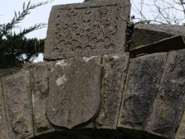 Medieval stone carving above the wall entrance